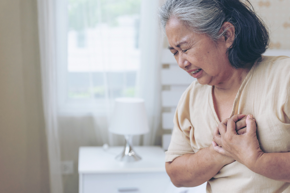 Elder woman with hands on chest, depicting discomfort linked to digestive problems